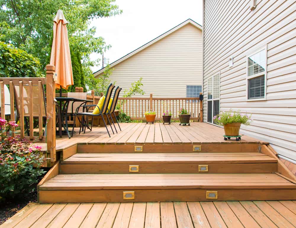 Patio And Garden Of Family Home At Summer. Deck Construction Lowell, MA