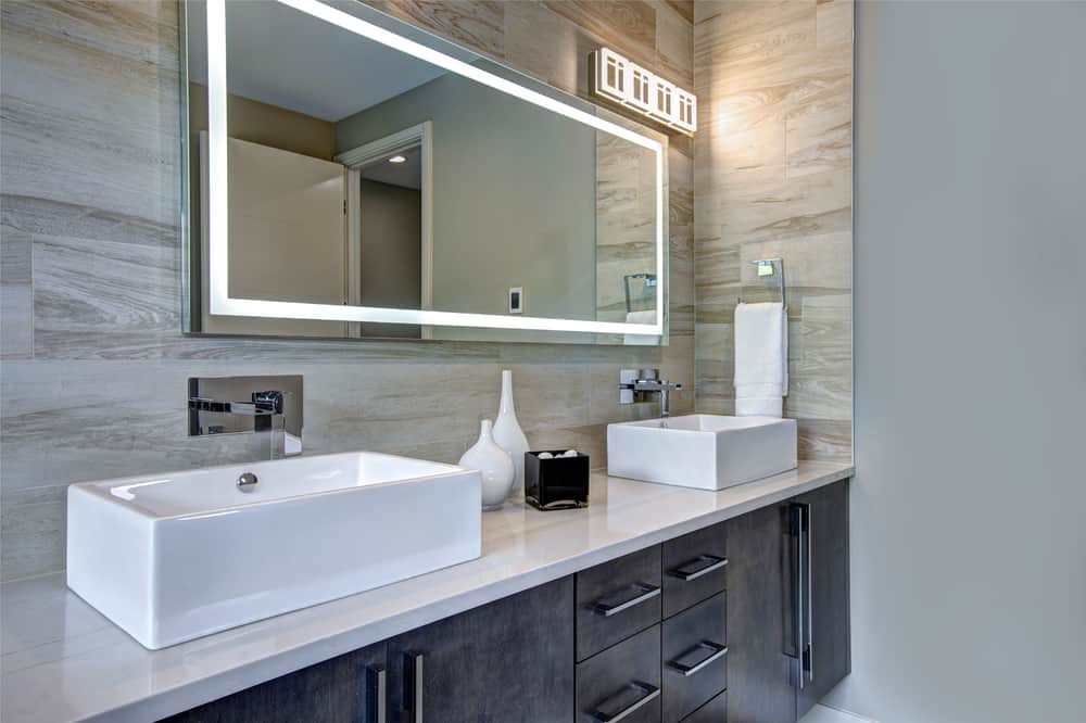 Contemporary Master Bathroom Features A Dark Vanity Cabinet Fitted With Lighting. Bathroom Remodeling Lowell MA